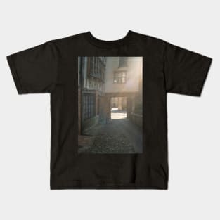 Medieval courtyard in Norwich bathed in sunlight Kids T-Shirt